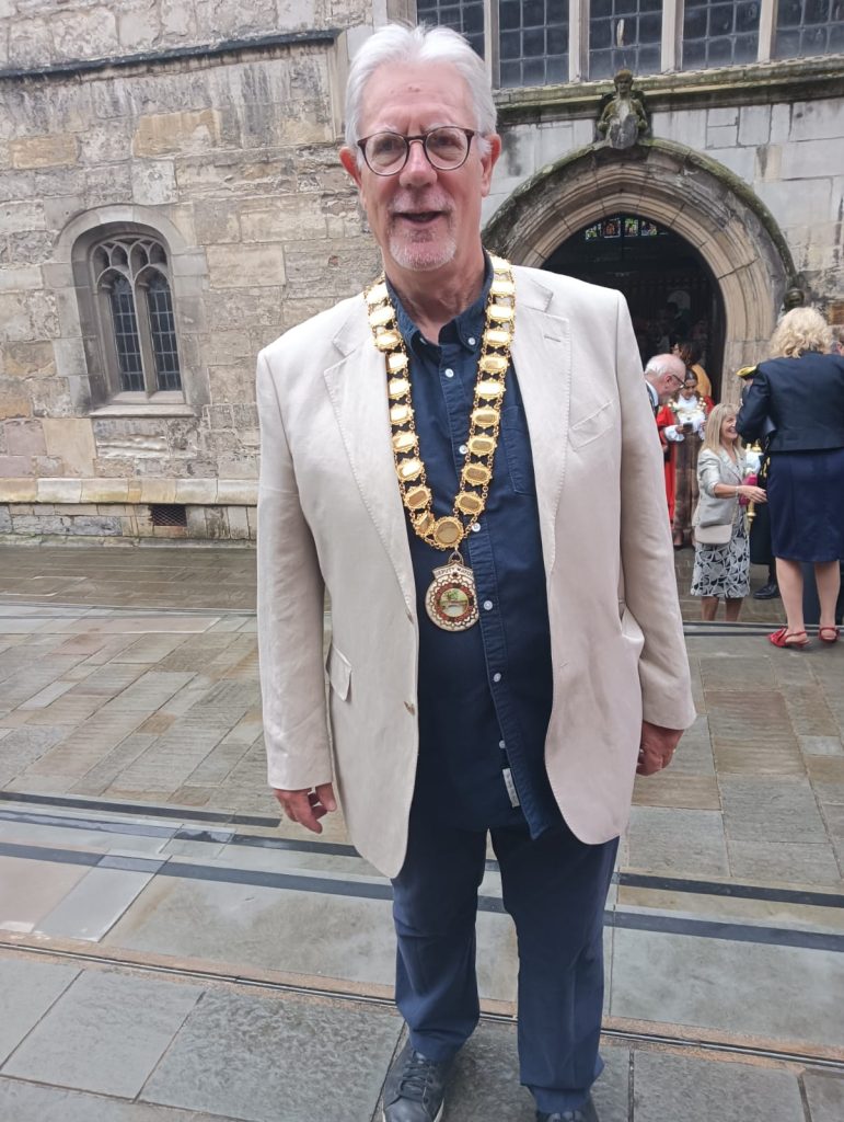 A photograph of Councillor Keith Butterick wearing the Deputy Mayoral Chains.